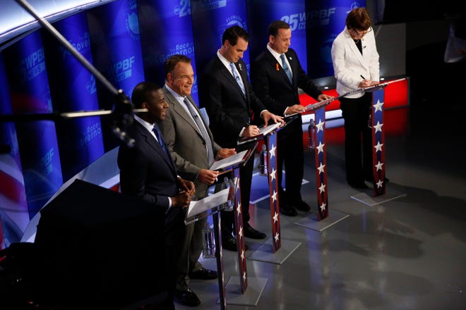 Democratic gubernatorial candidates, from right, Gwen Graham, Philip Levine, Chris King, Jeff Greene and Andrew Gillum await the start of a debate ahead of the Democratic primary for governor Thursday in Palm Beach Gardens. [Brynn Anderson/The Associated Press]