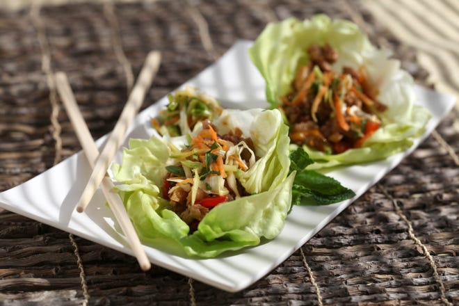 Most copycat recipes for P.F. Chang's spicy Asian lettuce wraps call for mixing the ground chicken with chopped mushrooms and water chestnuts, but you can make the wraps however you like. [Jessica J. Trevino/Detroit Free Press/TNS]