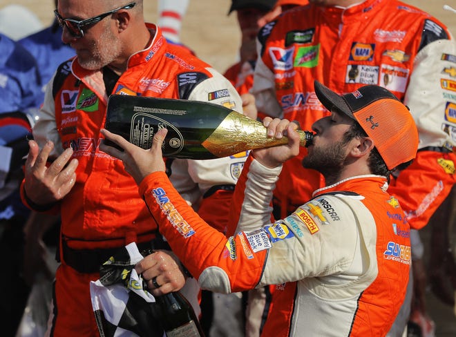 Chase Elliott takes a sip of champagne after winning the NASCAR Cup race in Watkins Glen. [THE ASSOCIATED PRESS]