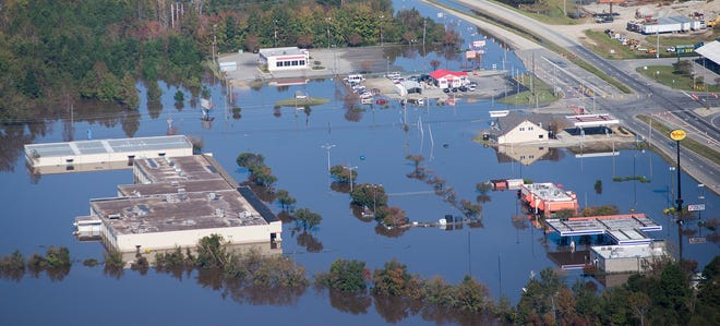 Flood waters from the Neuse River cover Kinston during Hurricane Matthew. Buyout funds will be available in a few months for people who have been waiting for nearly two years to rid themselves of property damaged by flooding from Hurricane Matthew in October 2016. [The Free Press]