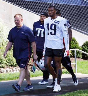 New England Patriots wide receiver Malcolm Mitchell (19) is escorted to the practice field during the team's NFL football training camp in Foxborough, Mass., Friday, July 27, 2018. (AP Photo/Charles Krupa)