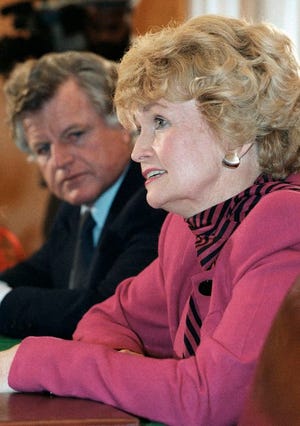 In this Dec. 10, 1985 file photo, Margaret Heckler answers a question on Capitol Hill in Washington at her confirmation hearing for ambassador to Ireland. At left is Sen. Edward M. Kennedy. Heckler, an eight-term Republican congresswoman from Massachusetts, secretary of Health and Human Services under President Ronald Reagan, and U.S. ambassador to Ireland, died Monday, Aug. 6, 2018, in Arlington, Va. She was 87. (AP Photo/Lana Harris)