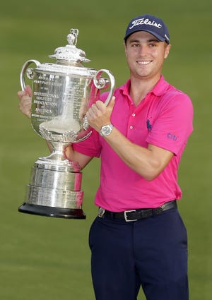 Justin Thomas poses with the Wanamaker Trophy after winning the PGA Championship on Aug. 13, 2017 at the Quail Hollow Club in Charlotte, N.C. This week, Thomas will try to join Tiger Woods as the only back-to-back winners of the PGA in stroke play. [CHUCK BURTON/AP FILE PHOTO]