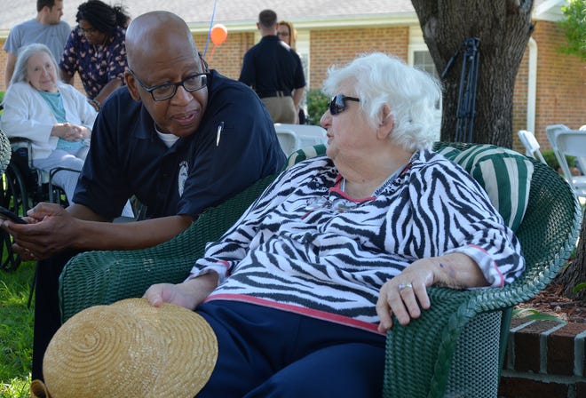 Officer William Hollowell of the New Bern Police Department talks with Anne Piner during the department's visit to the Courtyards at Berne Village assisted living facility Monday. The visit was part of the department's National Night Out, which will include visits to 18 communities on Tuesday. [TODD WETHERINGTON / SUN JOURNAL STAFF]