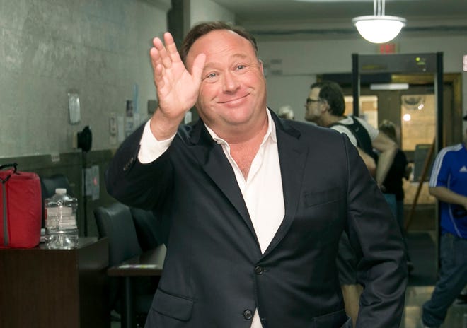 FILE - In this Wednesday, April 19, 2017, file photo, Alex Jones, a right-wing radio host and conspiracy theorist, arrives for a child custody trial at the Heman Marion Sweatt Travis County Courthouse in Austin, Texas. The music streaming service Spotify says it has removed some episodes of “The Alex Jones Show” podcast for violating its hate content policy. The company said late Wednesday that it takes reports of hate content seriously and reviews any podcast or song reported by customers. (Jay Janner/Austin American-Statesman via AP, File)
