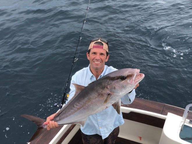 Donald Trump Jr. holds one of his catches, an amberjack, during an Aug. 2 fishing trip in Destin.