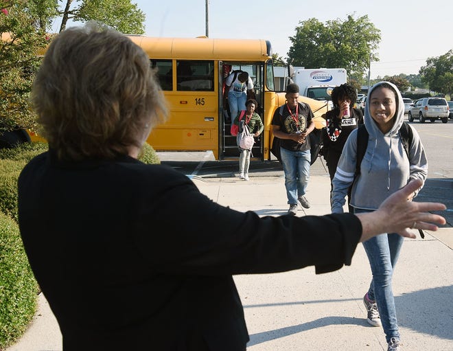 Diane Heath, principal of Lenoir County Early College High School, greets sophomore Tinya Blake on the first day of school Monday. [Submitted photo]