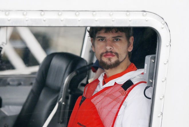 Nathan Carman arrives in a small boat at the US Coast Guard station in Boston, Tuesday, Sept. 27, 2016. Carman spent a week at sea in a life raft before being rescued by a passing freighter. (AP Photo/Michael Dwyer)