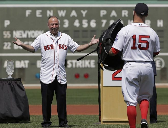 Red Sox broadcaster Jerry Remy, left, is presented with a giant baseball glove by Boston Red Sox's Dustin Pedroia during ceremonies held to celebrate Remy's 30 years in the broadcast booth last season at Fenway Park.
