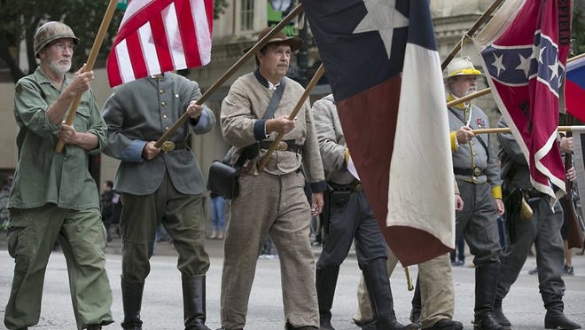 Members of a Confederate heritage group march in the Veterans Day parade in downtown Austin on Nov. 11, 2016. CREDIT: Ralph Barrera/American-Statesman