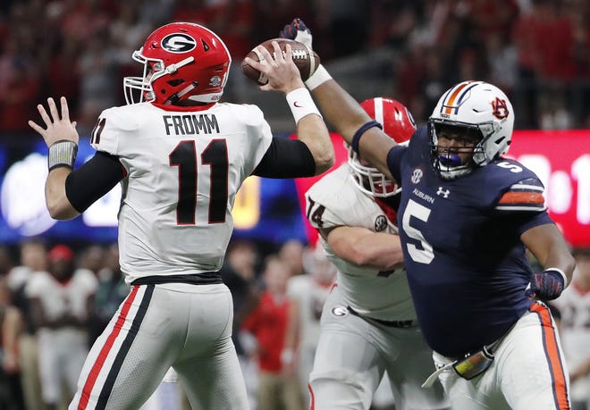 In this Dec. 2, 2017 photo, Georgia quarterback Jake Fromm (11) is hurried by Auburn defensive lineman Derrick Brown (5) during the second half of the SEC championship game in Atlanta. Auburn has a star in Brown, a 325-pound rock in the middle of what could be the SEC's best defensive line. [AP PHOTO/DAVID GOLDMAN]