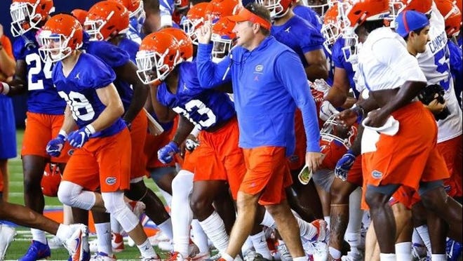 Florida coach Dan Mullen leads the team out of the Indoor Practice Facility during a recent practice. (Brad McClenny / The Gainesville Sun)