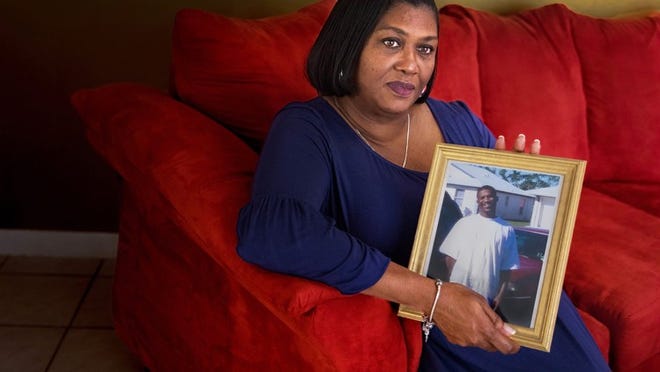 Linda Tomlinson holds a picture of her son, Eric Flint, in her home in West Palm Beach on July 30, 2018. Flint was killed January 12, 2005 when he and friend Christopher Dean botched an attempted burglary at a home on Village Boulevard. Dean was sentenced to life in prison because he was a felon who committed second-degree murder soon after being released. He appealed the sentence all the way to the state Supreme Court but was sentenced to life again on Thursday. (Greg Lovett / The Palm Beach Post)