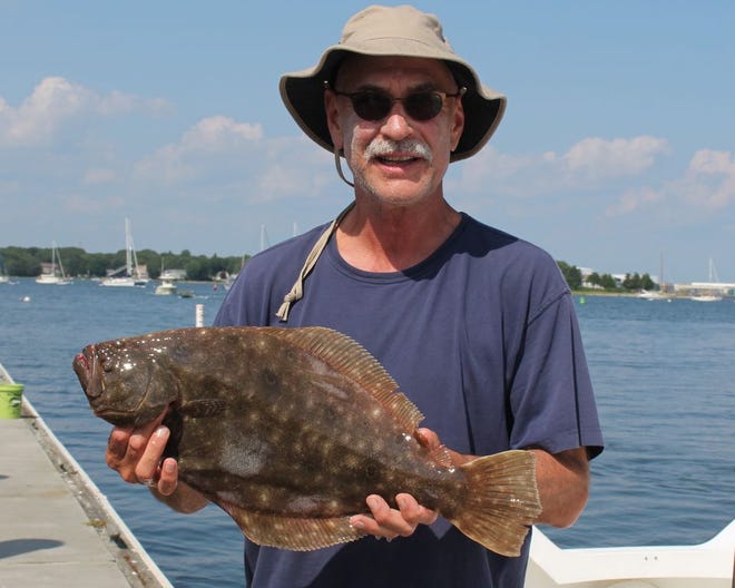Kevin Fetzer of East Greenwich with the 24-inch fluke he caught this weekend fishing Hull Cove, Jamestown.