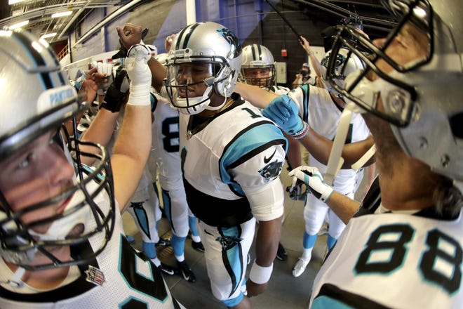 Carolina quarterback Cam Newton, center, gives a pep talk to his team before taking the field prior to a preseason game against the Buffalo Bills on Thursday in Orchard Park, N.Y. [Julio Cortez/Associated Press]