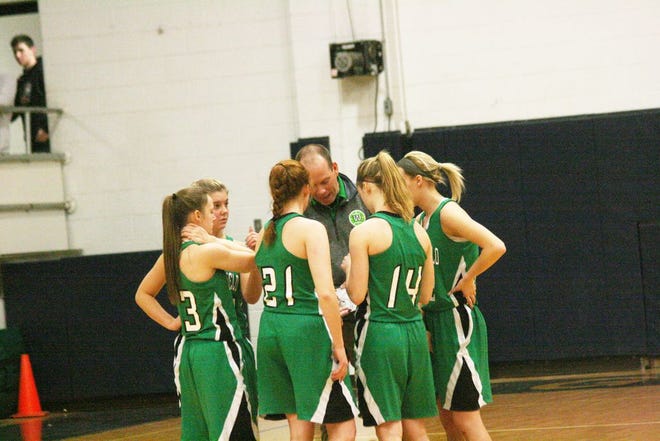 Shane Tucker talks with the Lady Geese prior to tip-off of a game last season. Tucker held a 99-63 record in his five seasons as head coach.