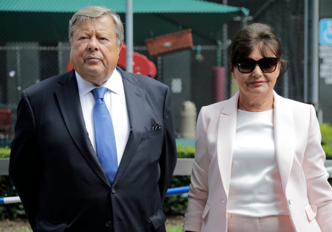 Viktor and Amalija Knavs listen as their attorney makes a statement in New York, Thursday, Aug. 9, 2018. First lady Melania Trump's parents have been sworn in as U.S. citizens. A lawyer for the Knavs says the Slovenian couple took the citizenship oath on Thursday in New York City. They had been living in the U.S. as permanent residents. (AP Photo/Seth Wenig)