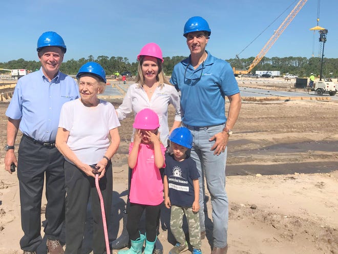 Security First Insurance Chairman and President Locke Burt, left, stands on the site of his company's future headquarters with several members of his family on Wednesday, Aug. 8, 2018. Also pictured from the left are his mother, Alice "Lupe" Burt, his daughter Mellisa Burt DeVriese (the company's chief administrative officer and general counsel), and her husband Eric DeVriese (founder of RealTime CPAs) and their children, Annamarie, 6, and Henry, 4. [NEWS-JOURNAL/CLAYTON PARK]