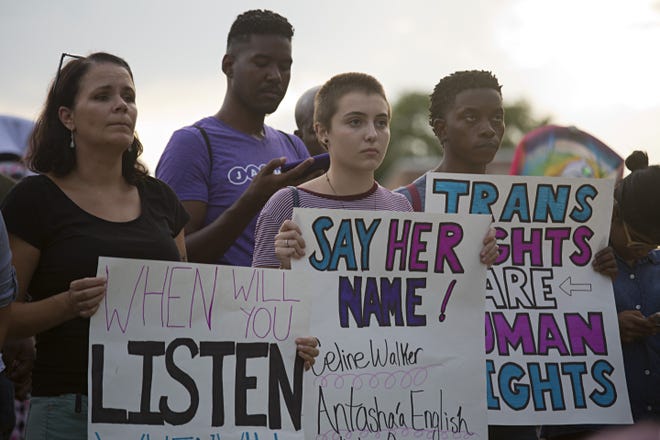 One of the signs at a June 27 rally in Jacksonville bore the names of some of the transgender women killed. [Aldrin Capulong for ProPublica]
