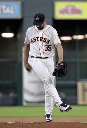 Astros starting pitcher Justin Verlander reacts after giving up a hit to the Seattle Mariners during the first inning of Thursday's game in Houston. The Mariners scored three runs in the inning. [David J. Phillip/AP Photo]