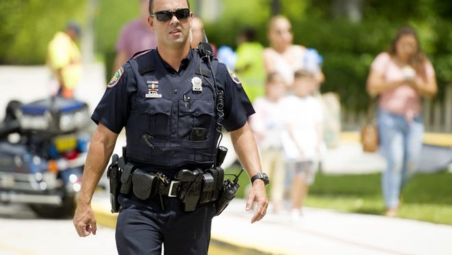Palm Beach Police Officer Ryan Burgoon attends Palm Beach Public Elementary's open house this week. Burgoon received training work as a campus police officer at the school. (Meghan McCarthy / Daily News)