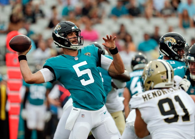 Jacksonville Jaguars quarterback Blake Bortles (5) throws a pass as he is pressured by New Orleans Saints defensive end Trey Hendrickson (91) Thursday at TIAA Bank Field in Jacksonville. [John Raoux/The Associated Press]