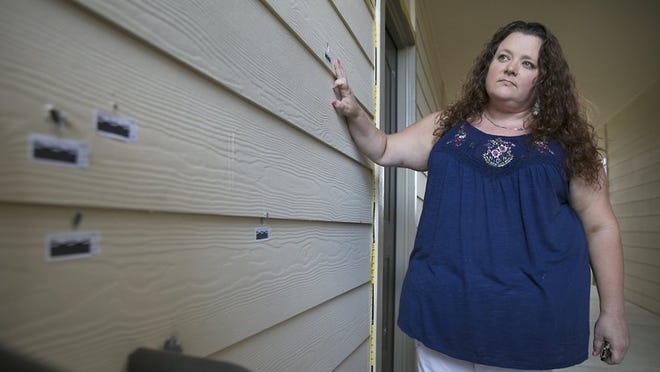 On Saturday, Julie Glidewell surveys some of the bullet holes that pock units at Highland Luxury Apartments in Pflugerville, where she lives. Glidewell said nearly 20 bullets entered her apartment overnight Wednesday, when police say one of her neighbors, 31-year-old David Deluna, fired more than 100 rounds into units at the complex. Ralph Barrera / American-Statesman
