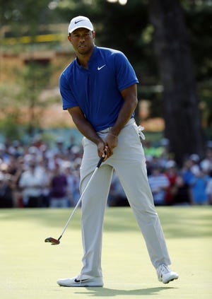 Tiger Woods looks at his putt on the 15th green during the third round of the PGA Championship golf tournament at Bellerive Country Club, Saturday in St. Louis. [Charlie Riedel/The Associated Press]