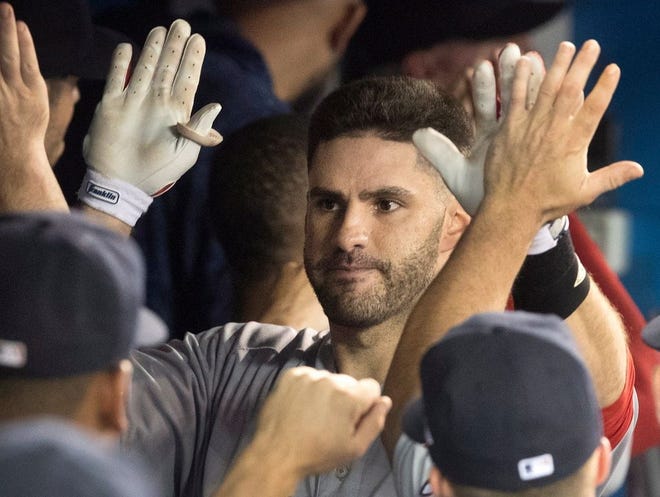 J.D. Martinez is greeted in the dugout after hitting a three-run homer against Toronto on Aug. 7.