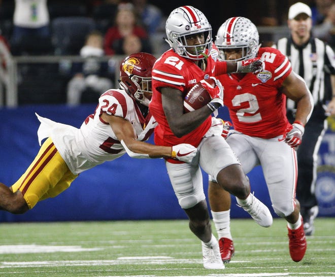 Parris Campbell runs through a tackle attempt by USC cornerback Isaiah Langley in the Cotton Bowl, a game in which Campbell broke two long gains. The Buckeyes' H-back averaged 17.7 yards every time he touched the ball last season. [Joshua A. Bickel/Dispatch]