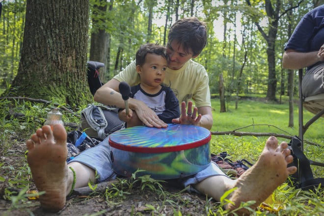 Kristina Byrne drums with her son, Adisa Jones, 2, at the Center for Spirituality in Nature's monthly outdoor service, dubbed Church of the Wild. [DAYNA SMITH FOR THE WASHINGTON POST]