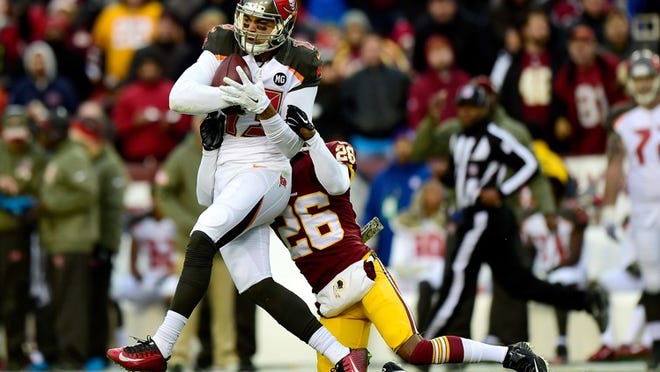 LANDOVER, MD - NOVEMBER 16: Wide receiver Mike Evans #13 of the Tampa Bay Buccaneers is tackled by cornerback Bashaud Breeland #26 of the Washington Redskins late in the third quarter at FedExField on November 16, 2014 in Landover, Maryland. (Photo by Patrick McDermott/Getty Images)