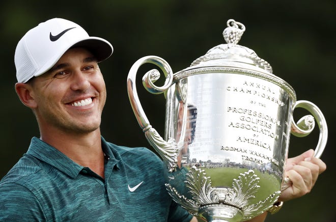 Brooks Koepka holds the Wanamaker Trophy after he won the PGA Championship golf tournament at Bellerive Country Club, Sunday in St. Louis. [AP Photo/Brynn Anderson]