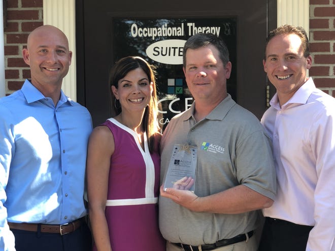 From left, Co-CEOs Stephen and Chris Albanese, along with Shannon Albanese, director of talent acquisition and development, presents Kevin Stafford, director of the Montgomery clinic, with an award to celebrate his 10 years of service during Access Physical Therapy’s 15th anniversary celebration last month. [PHOTO PROVIDED]