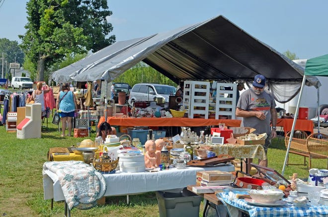 Tents and tables filled with items at a US-12 garage sale.
