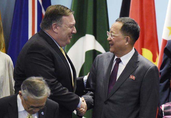 U.S. Secretary of State Mike Pompeo, left, greets North Korean Foreign Minister Ri Yong-ho at the 25th ASEAN Regional Forum Retreat in Singapore on Aug. 4. [JOSEPH NAIR/THE ASSOCIATED PRESS]