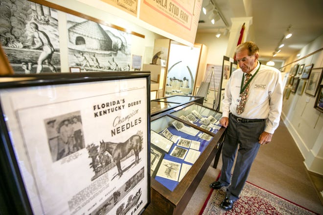 Volunteer Richard Cardinali looks over an exhibit featuring sports at the Marion County Museum of History and Archaeology in Ocala. The museum is a research and teaching institution located in the McPherson County Government Complex at 307 SE 26th Terrace. [Alan Youngblood/Staff photographer]