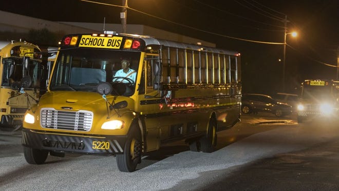 Palm Beach County School District busses leave the depot in Riviera Beach for their routes on the first day of school Monday, August 13, 2018.  (Lannis Waters / The Palm Beach Post)