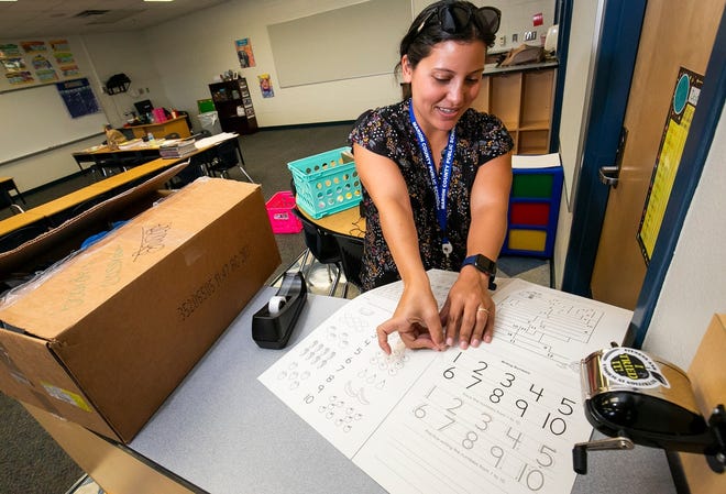 A teacher prepares her elementary school classroom for the return of students. [Doug Engle/Ocala Star-Banner]