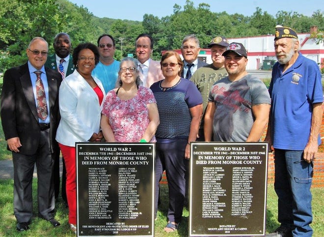 Members of the East Stroudsburg Elks Lodge 319 and members of the American Legion Post 903 place the World War II plaques at the Tannersville War Memorial. Pictured from left are: Ralph Bush, Jerome Henderson, Janell Henderson, Ken Stevens, Donna Stevens, Mark Hutson, Pat Bush and Jerry Richardson, all of the Elks Lodge; and Bill Hamilton, Dave Newcomb and Tom Bowditch, of the American Legion Post 903 and Monroe County Joint Honor Guard. [PHOTO PROVIDED]