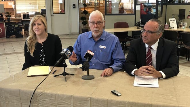 Earl Stewart (center), owner of Earl Stewart Toyota in Lake Park, flanked by his attorneys Dori Stibolt (left) and Gary Dunkel, held a press conference Monday to explain why it advertised exclusively for female sales associates last year, and was later sued for discrimination by a man who was not hired for the position. (Jodie Wagner/The Palm Beach Post)