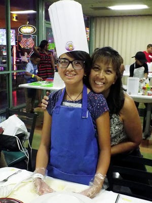 Local junior chef Autumn Punsal with her mother, Maria Punsal. The young chef will compete this week in the finals of the John’s Incredible Pizza Kids Cook-Off Championship in Las Vegas. [Photo courtesy of Maria Punsal/David Barrett]