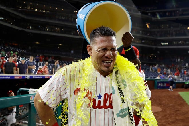 The Phillies' Wilson Ramos is doused by Odubel Herrera after the Phillies' 7-4 win against the Red Sox on Wednesday. [Matt Slocum/The Associated Press]