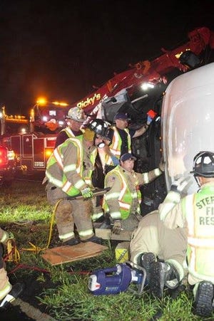 Sterling first responders work on a tractor trailer that overturned on Route 12. [STERLING FIRE DEPARTMENT FACEBOOK PHOTO]