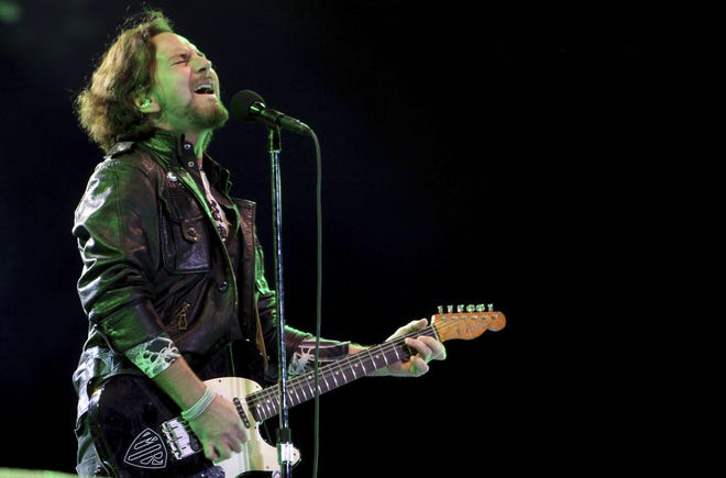 Pearl Jam's lead vocalist Eddie Vedder performs in concert in Brazil in 2011. Republicans are condemning a poster by Pearl Jam that shows the White House in flames and a bald eagle pecking at a skeleton they say is meant to depict President Donald Trump. [AP Photo / Andre Penner, file]