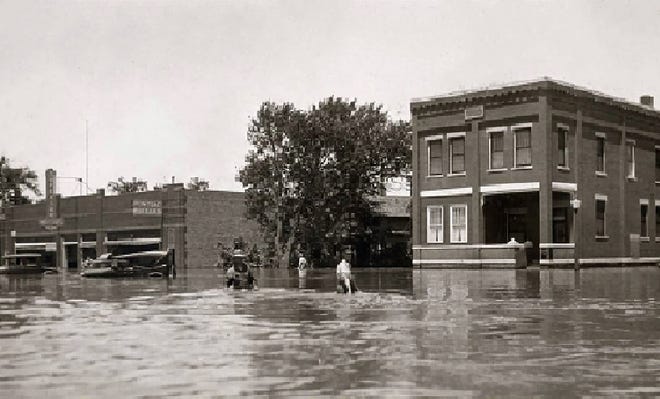 The building at 108 W. First Ave. was built right around 1920 and started as Superior Motors, shown here during the 1929 flood, along with the Gage-Hall Clinic at 100 W. First Ave. [Conard - Harmon Collection]