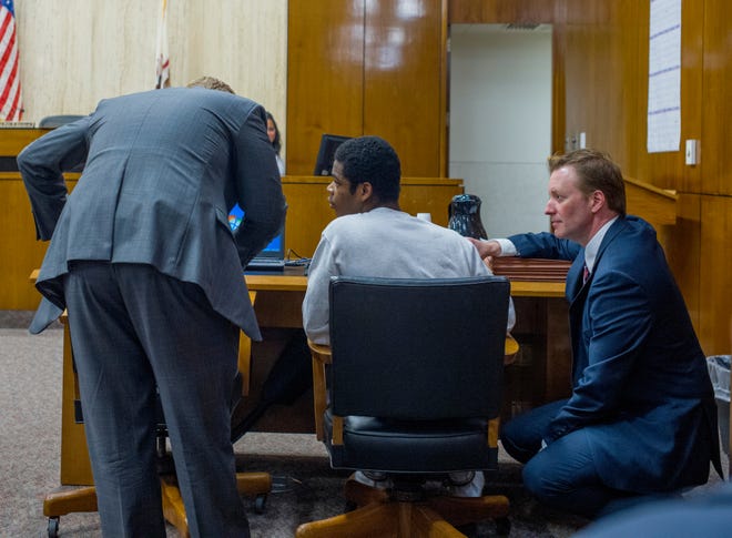DAVID ZALAZNIK/Journal Star Jermontay Brock, center, talks with his attorneys, chief public defender Nate Bach, left, and first assistant public defender Kevin Lowe during a hearing before Circuit Court Judge Paul Gilfillan Thursday at the Peoria County Courthouse. Brock, 16, has been charged with first-degree murder in the April 8 killing of two people at an off-campus party near Bradley University.
