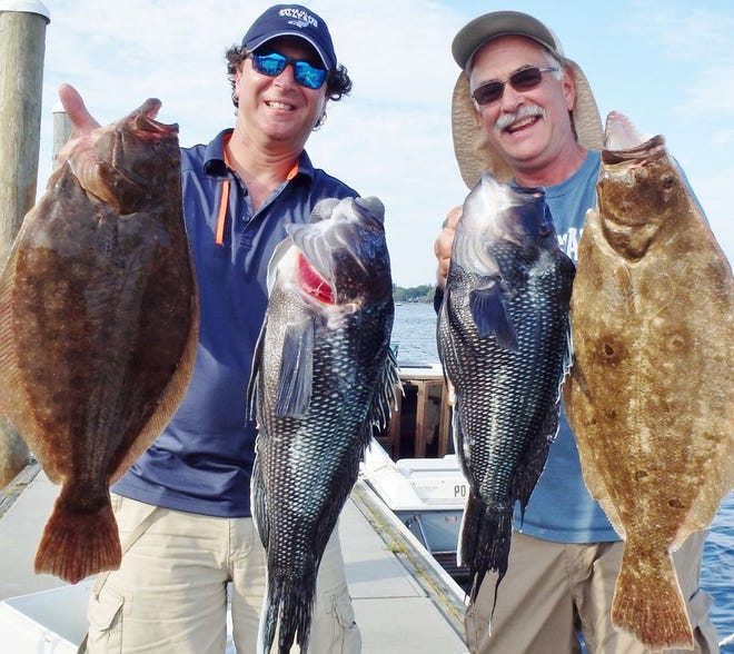 Steve Brustein, left, of West Warwick and Kevin Fetzer of East Greenwich with summer flounder (fluke) and black sea bass they caught while fishing the Block Island Wind Farm area.