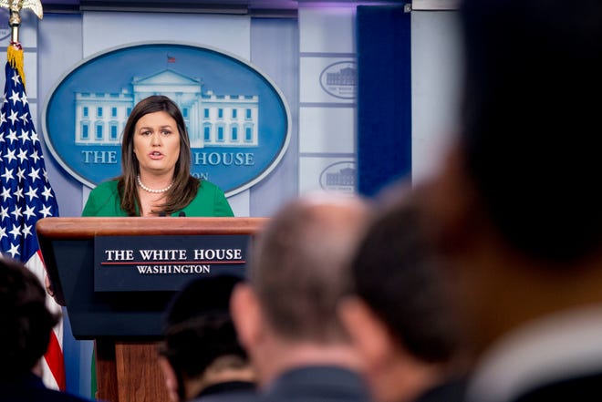 White House press secretary Sarah Huckabee Sanders reads a statement from President Donald Trump announcing that he will remove the security clearance from former CIA Director John Brennan during the daily press briefing on Wednesday at the White House. Sanders said the president will be reviewing the security clearances for a number of other former officials. [Andrew Harnik/The Associated Press]