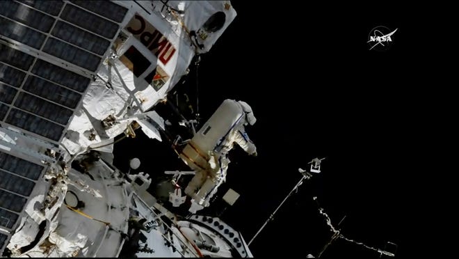 Cosmonaut Sergey Prokopyev flings a Sirius nano-satellite into orbit from the International Space Station on Wednesday. [NASA via AP]